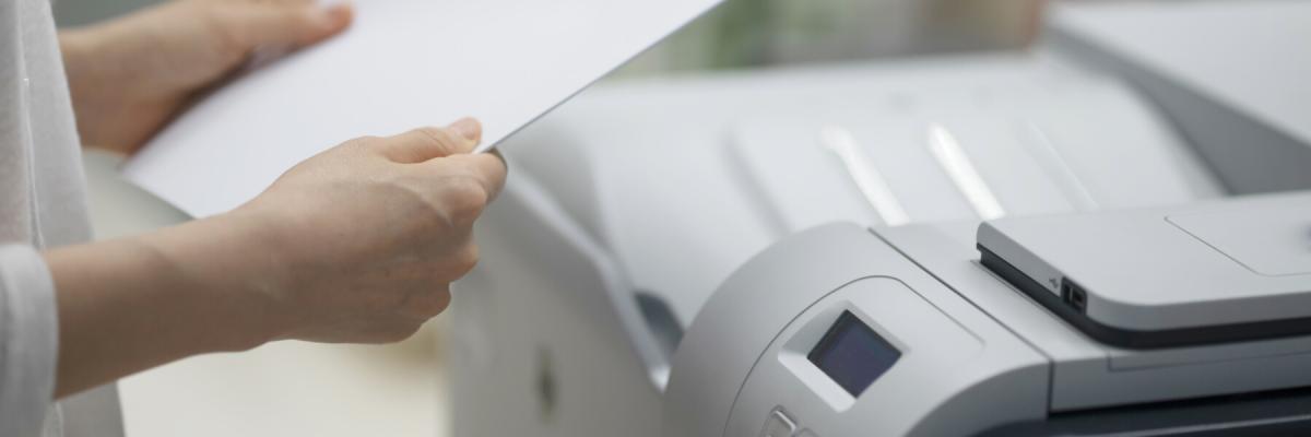 Businesswoman making copies with copy machine