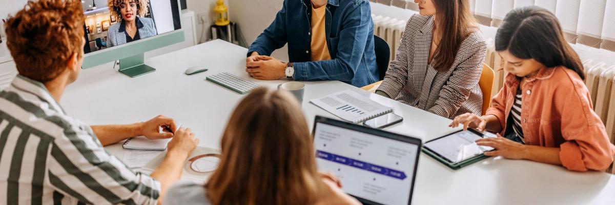 in-office workers talking to remote worker 