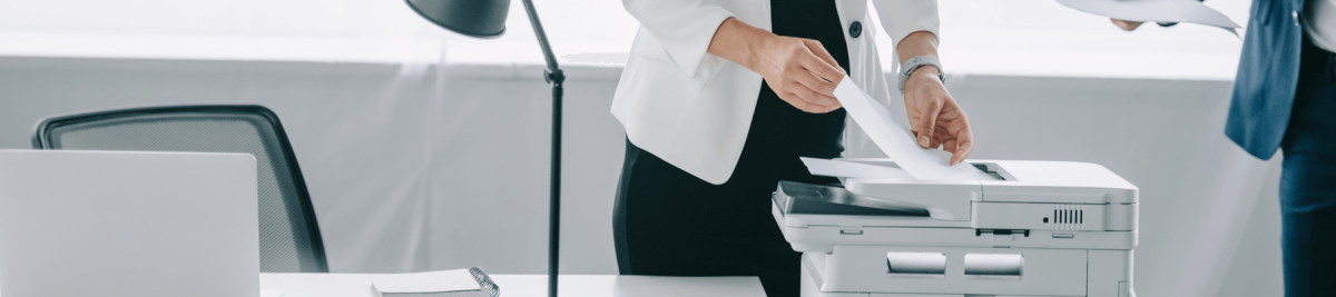 Woman using a printer in the office. 